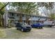 Row of townhouses showing the exteriors, with parking available directly in front and mature tree coverage at 507 Stinson Dr # 3A, Charleston, SC 29407