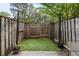Small fenced patio space with flower pots and artifical turf at 507 Stinson Dr # 3A, Charleston, SC 29407