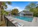 Community pool with lounge chairs and tropical trees at 507 Stinson Dr # 3A, Charleston, SC 29407