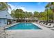 Community pool and lounge chairs with surrounding trees at 507 Stinson Dr # 3A, Charleston, SC 29407