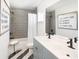 Clean bathroom featuring gray tiled walls, a modern vanity, and a tub with shower at 5223 Cottage Landing Dr, Summerville, SC 29485