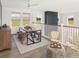 Lofted dining area features unique seating around a wooden table, and large windows with backyard views at 5223 Cottage Landing Dr, Summerville, SC 29485
