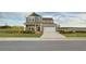 Beautiful two-story home with a two-car garage, charming front porch, and landscaped lawn at 5223 Cottage Landing Dr, Summerville, SC 29485