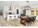 Open kitchen and dining area with stainless steel appliances, a kitchen island, and a dining table with chairs at 5223 Cottage Landing Dr, Summerville, SC 29485