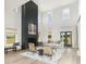 Bright living room with high ceilings, a fireplace, neutral decor, and natural light at 5223 Cottage Landing Dr, Summerville, SC 29485