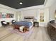 Spacious main bedroom with a tray ceiling, bench seating, a large window, and neutral tones at 5223 Cottage Landing Dr, Summerville, SC 29485