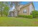Home's back exterior featuring a screened porch, patio area, and well maintained lawn at 5411 Nesting Pl, North Charleston, SC 29420