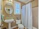 Cozy bathroom featuring a pedestal sink and shower with blue patterned curtain at 5411 Nesting Pl, North Charleston, SC 29420