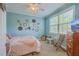 Bright bedroom with wood floors, ample natural light, and decorative accents at 5411 Nesting Pl, North Charleston, SC 29420