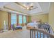 Comfortable bedroom featuring a ceiling fan, neutral walls, and lots of natural light from the windows at 5411 Nesting Pl, North Charleston, SC 29420