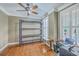 Bedroom with ceiling fan, hardwood flooring, natural lighting, and simple furnishing at 5411 Nesting Pl, North Charleston, SC 29420