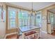 Charming dining room with natural light, rustic table and modern chandelier at 5411 Nesting Pl, North Charleston, SC 29420