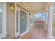 Inviting front porch adorned with a wreath, welcome mat, and lantern sconces showcasing southern charm at 5411 Nesting Pl, North Charleston, SC 29420