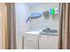 Functional laundry room with washer, dryer, and storage shelves at 5411 Nesting Pl, North Charleston, SC 29420