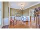 Bright living room showcasing a chandelier, hardwood floors, and classic wall trim at 5411 Nesting Pl, North Charleston, SC 29420