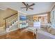 Cozy living room features a staircase, television and view to the kitchen at 5411 Nesting Pl, North Charleston, SC 29420