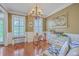 Inviting living room with hardwood floors, classic wall trim, and natural light from large windows at 5411 Nesting Pl, North Charleston, SC 29420