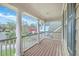 Inviting covered porch with wooden flooring, white columns, and picturesque neighborhood views at 5411 Nesting Pl, North Charleston, SC 29420