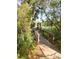 Charming wooden walkway leading through lush greenery to an arched gate at 5411 Nesting Pl, North Charleston, SC 29420