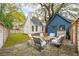 Backyard featuring a stone patio with furniture, lush lawn, and detached garage at 6 Beverly Rd, Charleston, SC 29407