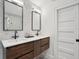 Modern bathroom with dual sinks, dark wood cabinets, quartz counters, and stylish fixtures at 6 Beverly Rd, Charleston, SC 29407