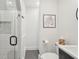 Clean, all-white bathroom with glass shower, modern fixtures, and minimalist decor at 6 Beverly Rd, Charleston, SC 29407