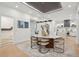 Open dining room features modern chandelier, marble table, and seamlessly flows into kitchen at 6 Beverly Rd, Charleston, SC 29407