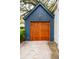Exterior garage with wood door at 6 Beverly Rd, Charleston, SC 29407