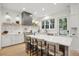 Charming kitchen featuring a white island, marble countertops, and stainless steel appliances, illuminated by natural light at 6 Beverly Rd, Charleston, SC 29407