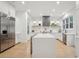 Spacious kitchen with white cabinets, a large island with seating, and stainless steel appliances at 6 Beverly Rd, Charleston, SC 29407
