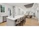 Open kitchen with a large island and seating, connected to a dining area, featuring light wood floors at 6 Beverly Rd, Charleston, SC 29407