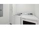 Well-lit laundry room with modern appliances and storage cabinet at 6 Beverly Rd, Charleston, SC 29407