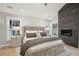 Stylish main bedroom features a fireplace, bedside tables with lamps, and neutral tones for a relaxing ambiance at 6 Beverly Rd, Charleston, SC 29407