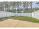 A backyard area with a concrete patio and a white wooden fence provides a secure outdoor space at 637 Hilchot Dr, Summerville, SC 29486