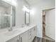 Bright bathroom with double sinks, a large mirror, and a separate shower area at 637 Hilchot Dr, Summerville, SC 29486