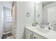 Bathroom with a vanity sink, large mirror, and shower/bathtub with decorative curtain at 637 Hilchot Dr, Summerville, SC 29486