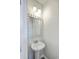 Stylish half bath with a pedestal sink, decorative mirror, and modern lighting at 637 Hilchot Dr, Summerville, SC 29486