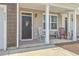 Inviting front porch with rocking chairs and a charming entrance, perfect for relaxing outdoors at 637 Hilchot Dr, Summerville, SC 29486