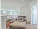 Neutral colored loft area with chair, ottoman, lots of natural light, and stairway to downstairs area at 637 Hilchot Dr, Summerville, SC 29486