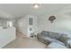Living room featuring neutral walls, neutral carpet, gray couch, and stairway to downstairs area at 637 Hilchot Dr, Summerville, SC 29486