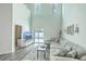 Open-concept living room featuring soaring ceilings, a large gray couch, and modern decor at 637 Hilchot Dr, Summerville, SC 29486