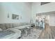 Spacious living room with hardwood floors, a plush sofa, and an adjacent kitchen area at 637 Hilchot Dr, Summerville, SC 29486