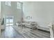 Bright living room with high ceilings, a comfortable couch, and sliding door access to the outdoors at 637 Hilchot Dr, Summerville, SC 29486