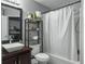 Bathroom featuring a modern vanity, a standing shelf, and a shower/tub combo at 8530 Bentwood Dr, North Charleston, SC 29406