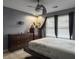Bedroom with wooden floors, a ceiling fan, a bed, and dresser near the windows with gray walls at 8530 Bentwood Dr, North Charleston, SC 29406