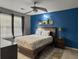 Comfortable main bedroom with blue accent wall, ceiling fan and a large window at 8530 Bentwood Dr, North Charleston, SC 29406