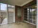 Enclosed patio space with an outdoor lattice door and sliding glass doors overlooking the backyard at 8530 Bentwood Dr, North Charleston, SC 29406