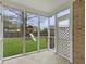 View of a backyard playground with a slide from an enclosed patio with lattice door access at 8530 Bentwood Dr, North Charleston, SC 29406