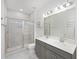 Bathroom featuring double sinks with gray cabinets, a glass shower, and tile flooring at 861 Recess Point Dr, Moncks Corner, SC 29461