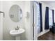 Clean half bathroom featuring a round mirror and white vanity at 861 Recess Point Dr, Moncks Corner, SC 29461
